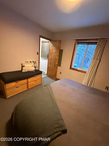 a bed sitting in a bedroom next to a window