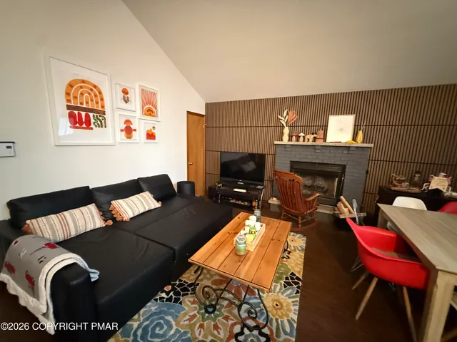 a living room with furniture rug and fireplace