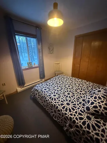 a large bed sitting in a bedroom next to a window
