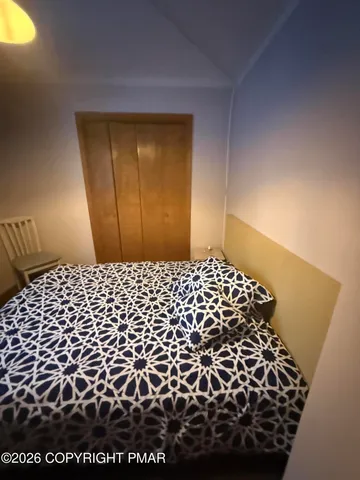 a bed sitting in a bedroom next to a window