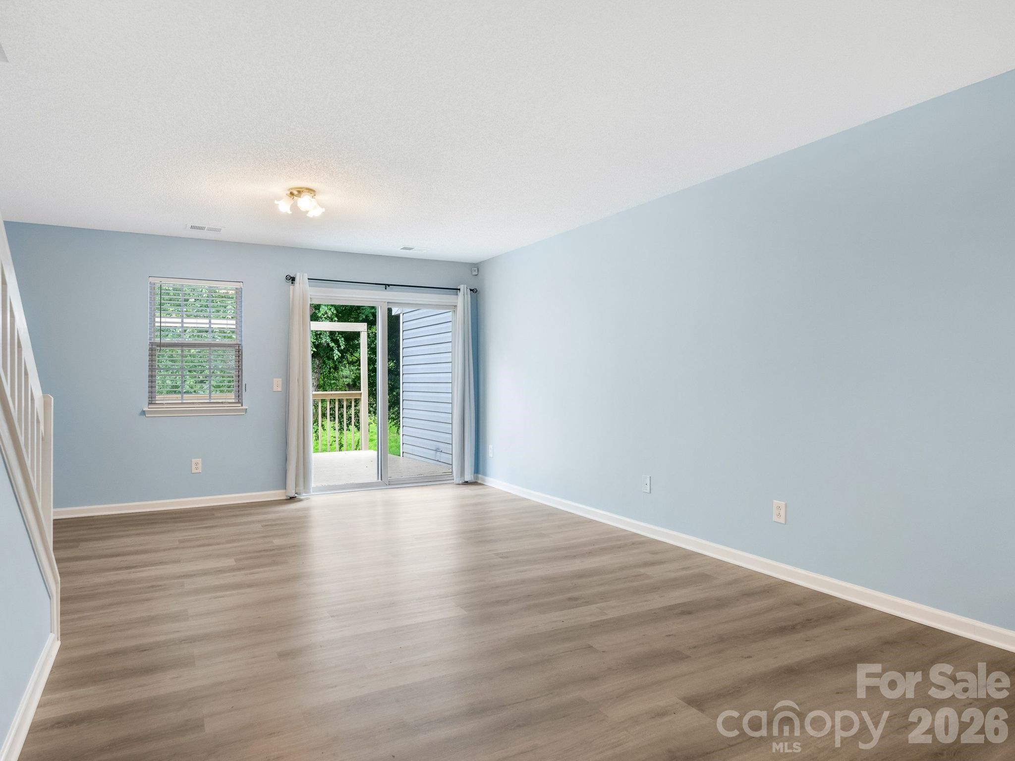 3259 Blythe Ridge Court Charlotte, NC 28213 - Photo 2 of 17 a view of an empty room with wooden floor and a window