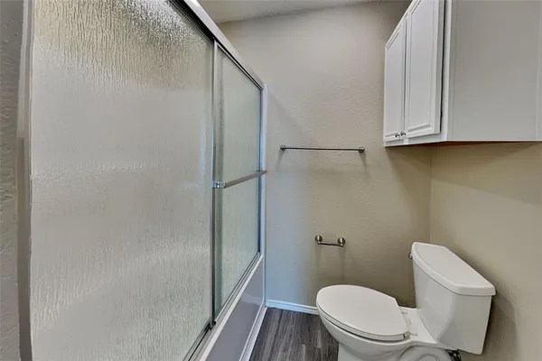 a white toilet sitting next to a bathroom sink