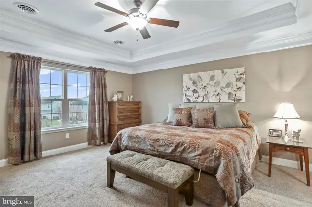 a bedroom with a large bed couch and a window