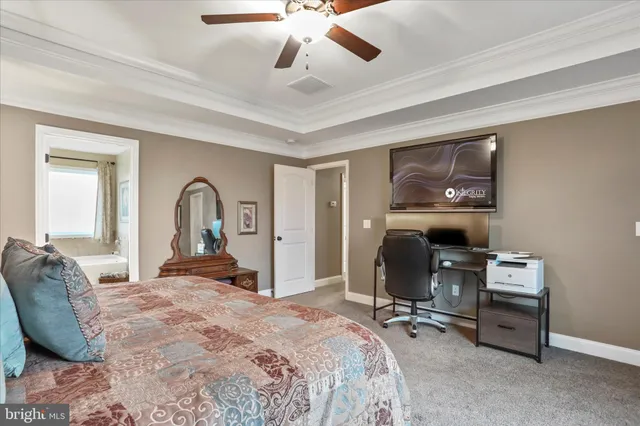 a bedroom with bed and a chandelier
