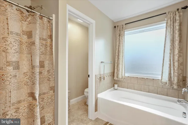 a bathroom with a bathtub and shower