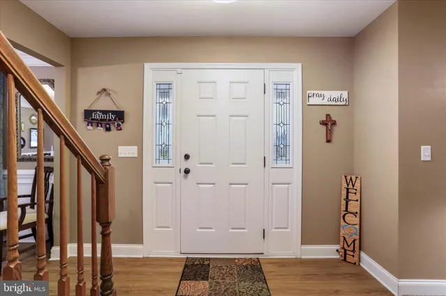 a view of an entryway with wooden floor