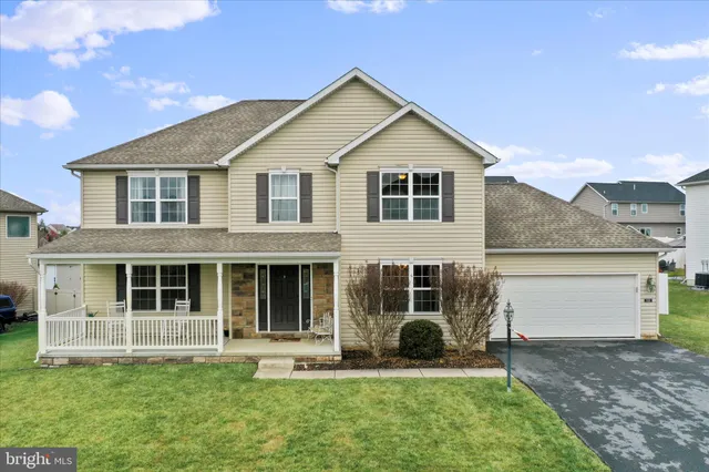 a view of a house with a yard and sitting area