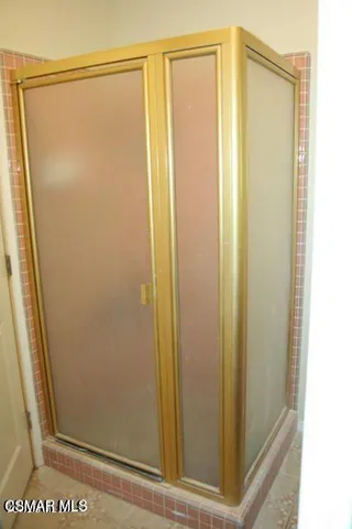 a bathroom with a glass shower door