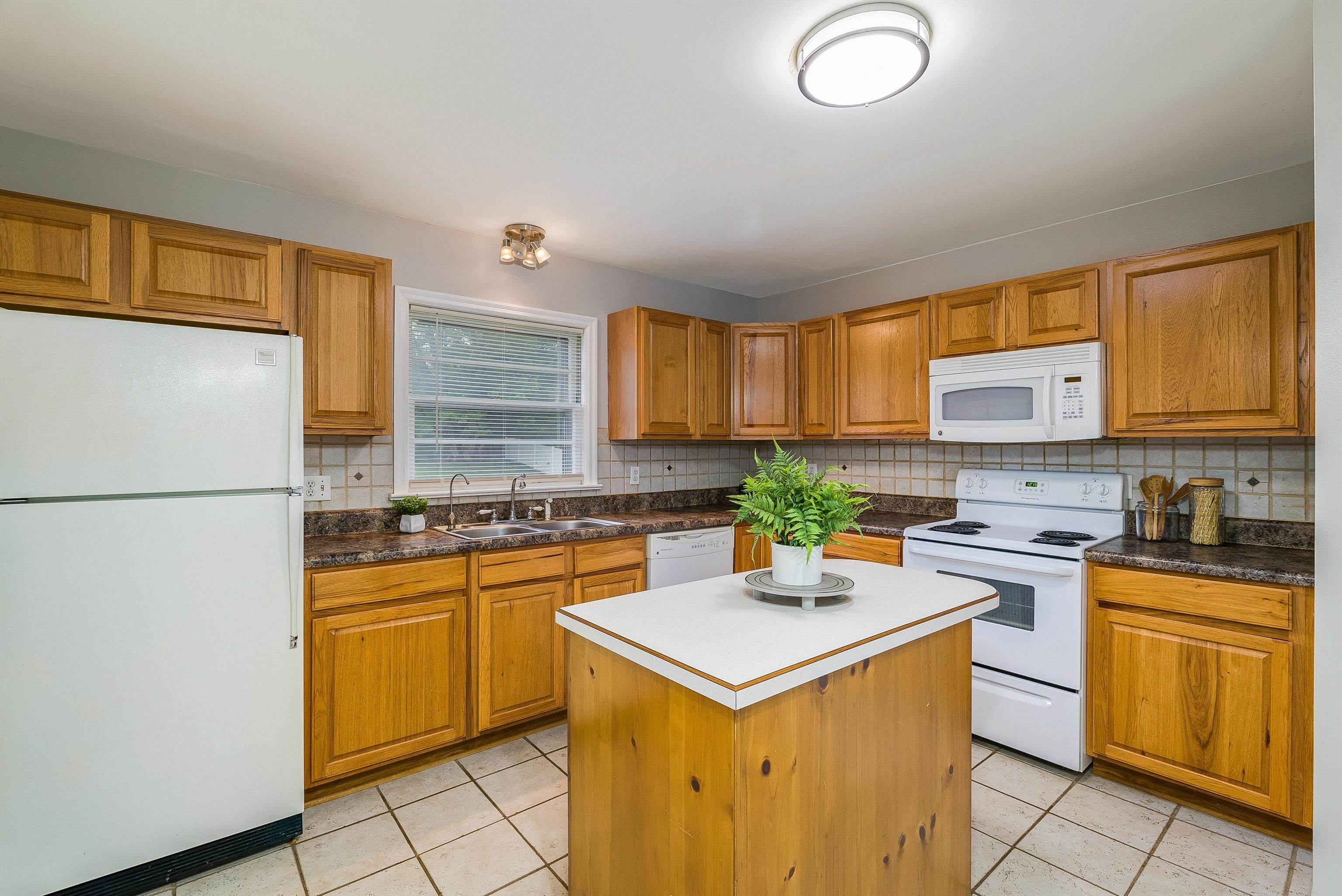 78 Stuart Avenue Stuarts Draft, VA 24477 - Photo 13 of 41 a kitchen with a sink a stove top oven a refrigerator a counter top space and cabinets
