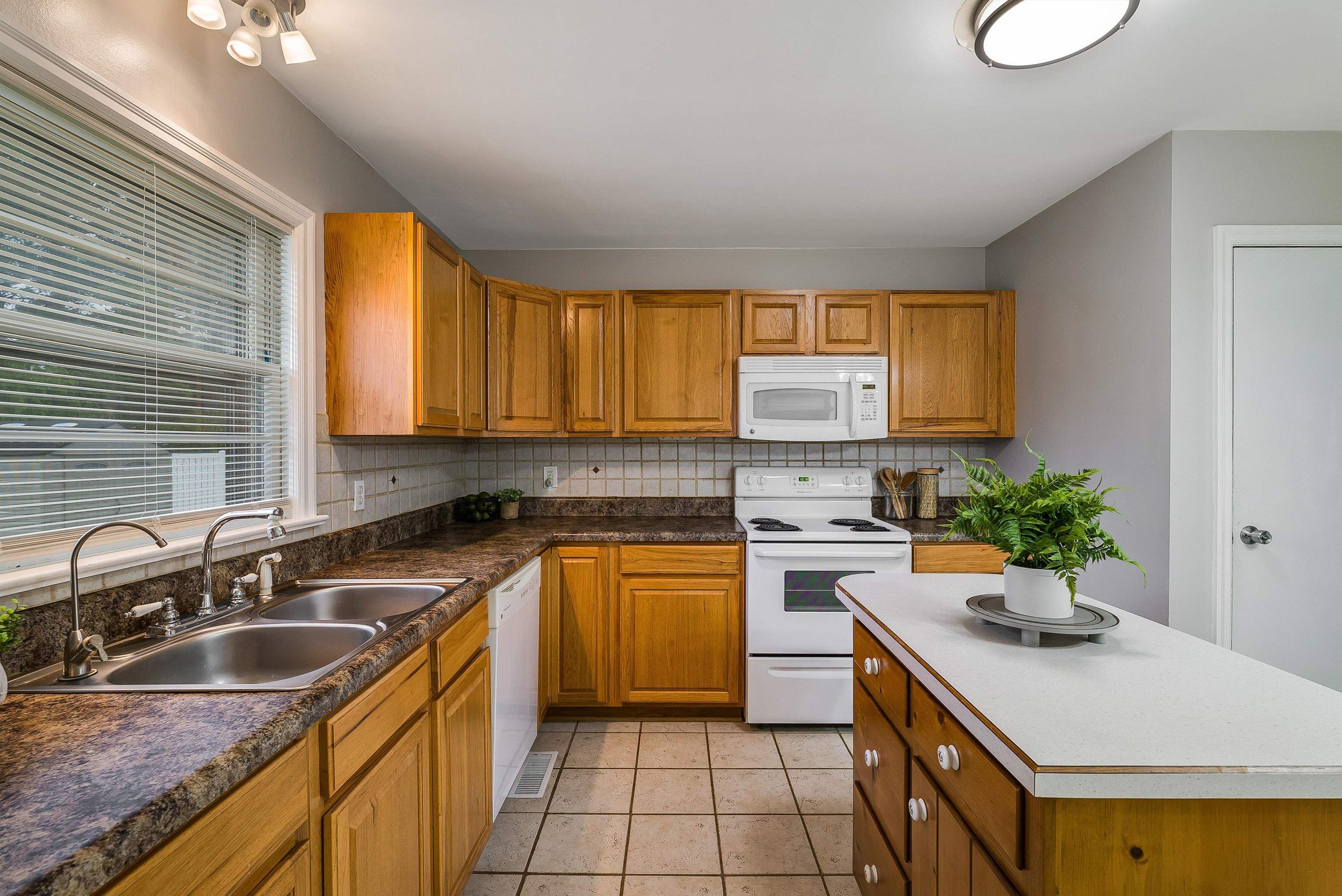 78 Stuart Avenue Stuarts Draft, VA 24477 - Photo 14 of 41 a kitchen with a sink stove and cabinets