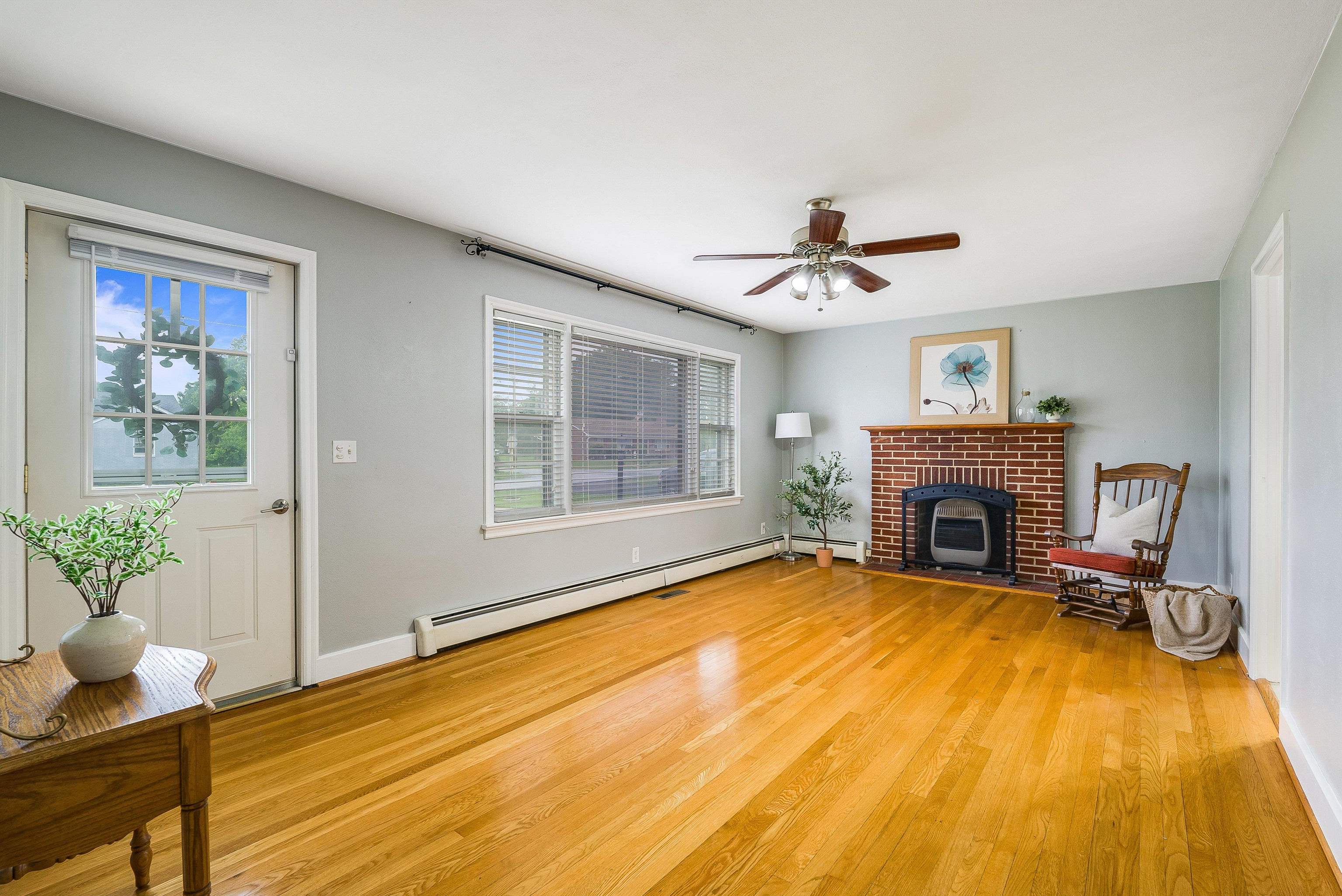 78 Stuart Avenue Stuarts Draft, VA 24477 - Photo 8 of 41 a view of an empty room with a fireplace and a chandelier