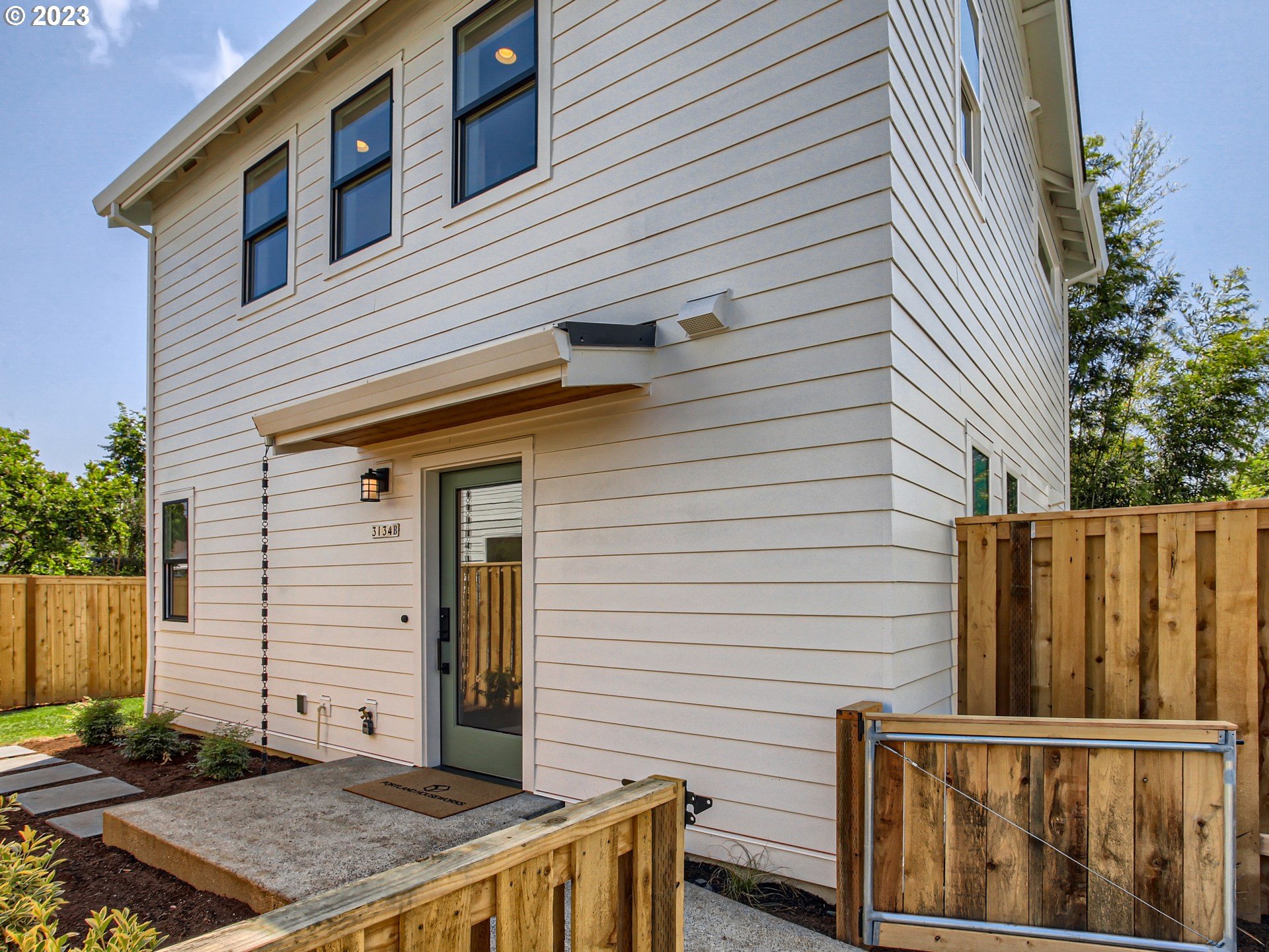 a view of a house with a small deck