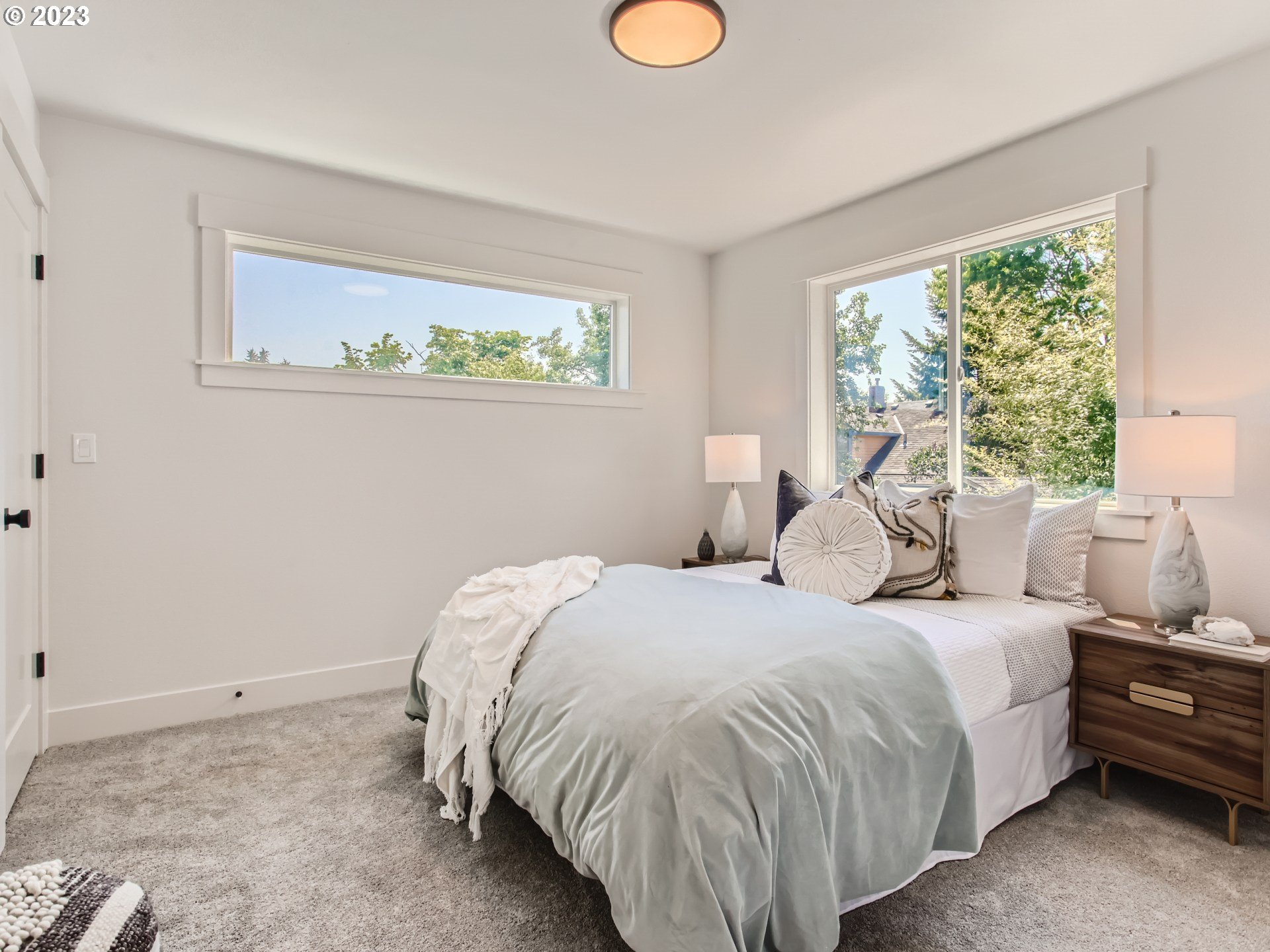 3134 North Winchell Street, Unit B Portland, OR 97217 - Photo 18 of 24 a bedroom with a bed and window