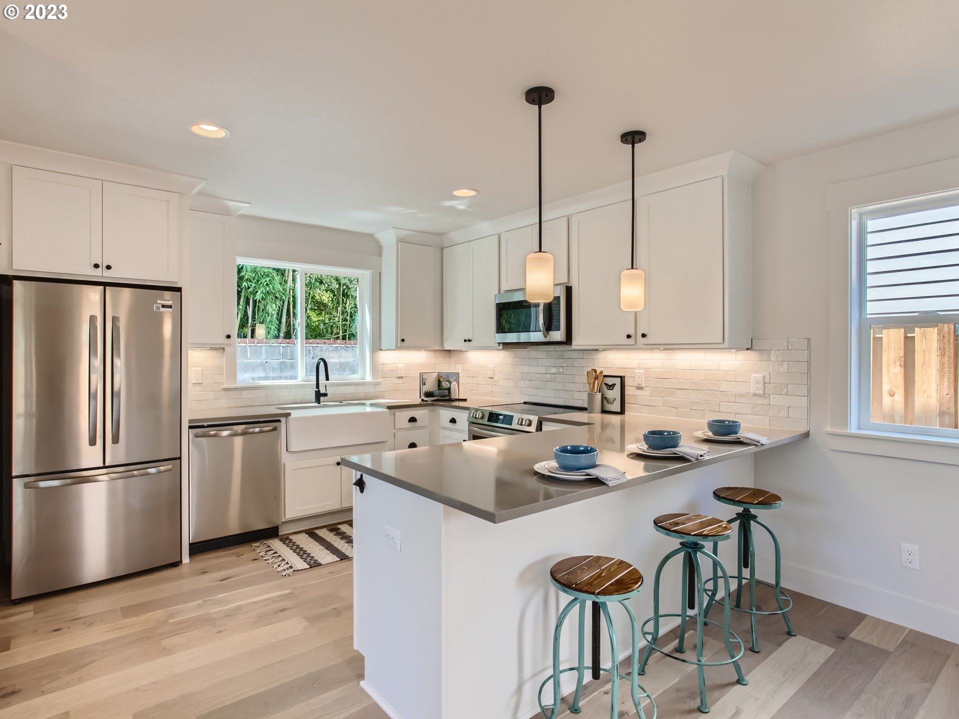 3134 North Winchell Street, Unit B Portland, OR 97217 - Photo 10 of 24 a kitchen with refrigerator a stove a sink and a chairs