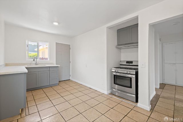 a view of cabinets a sink and dishwasher in a bathroom