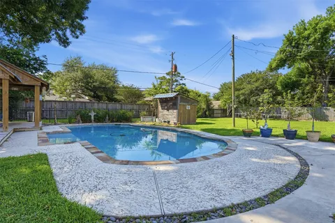 a view of a backyard with swimming pool