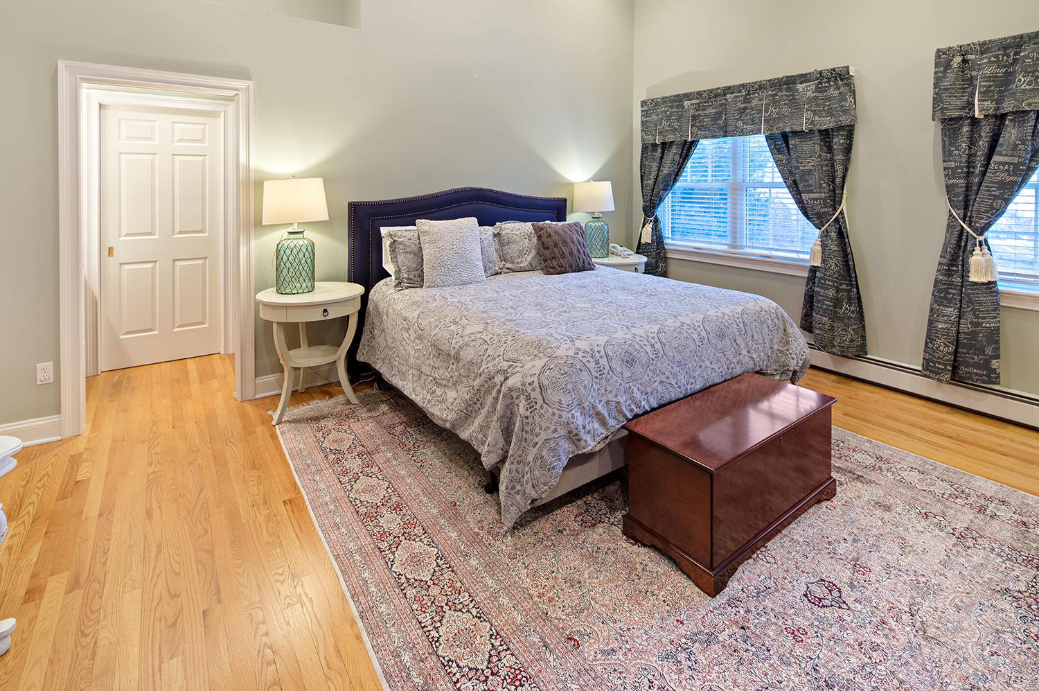 14 Chasmars Pond Road Darien, CT 06820 - Photo 17 of 34 a spacious bedroom with a bed and wooden floor