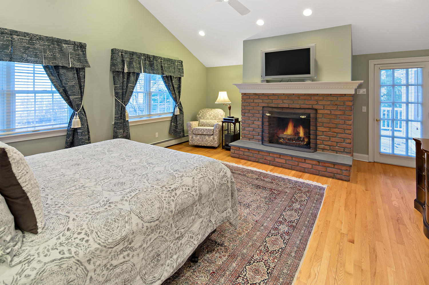 14 Chasmars Pond Road Darien, CT 06820 - Photo 18 of 34 a living room with a fireplace and a flat screen tv