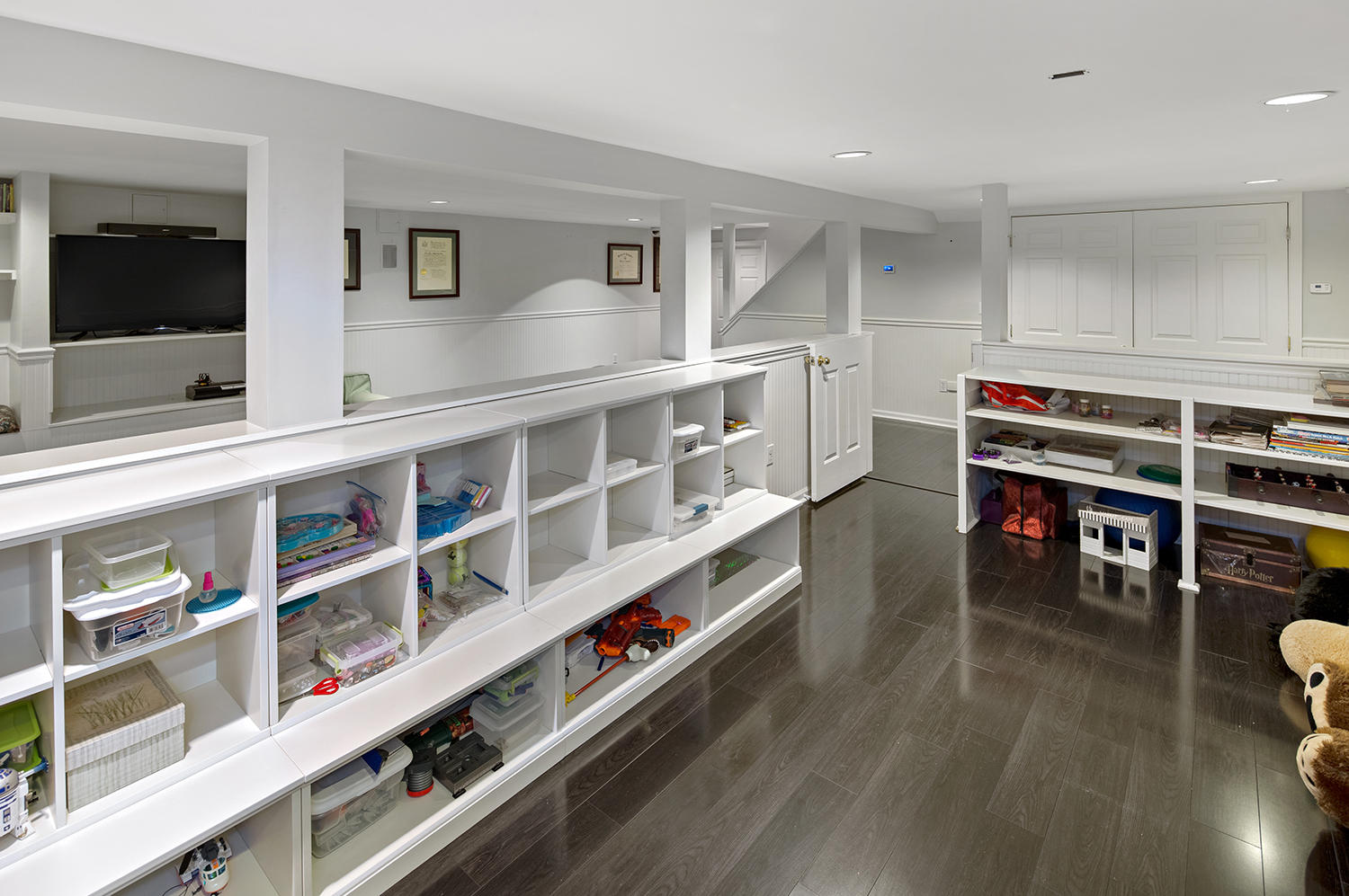 14 Chasmars Pond Road Darien, CT 06820 - Photo 29 of 34 a room with furniture a flat screen tv and a book shelf