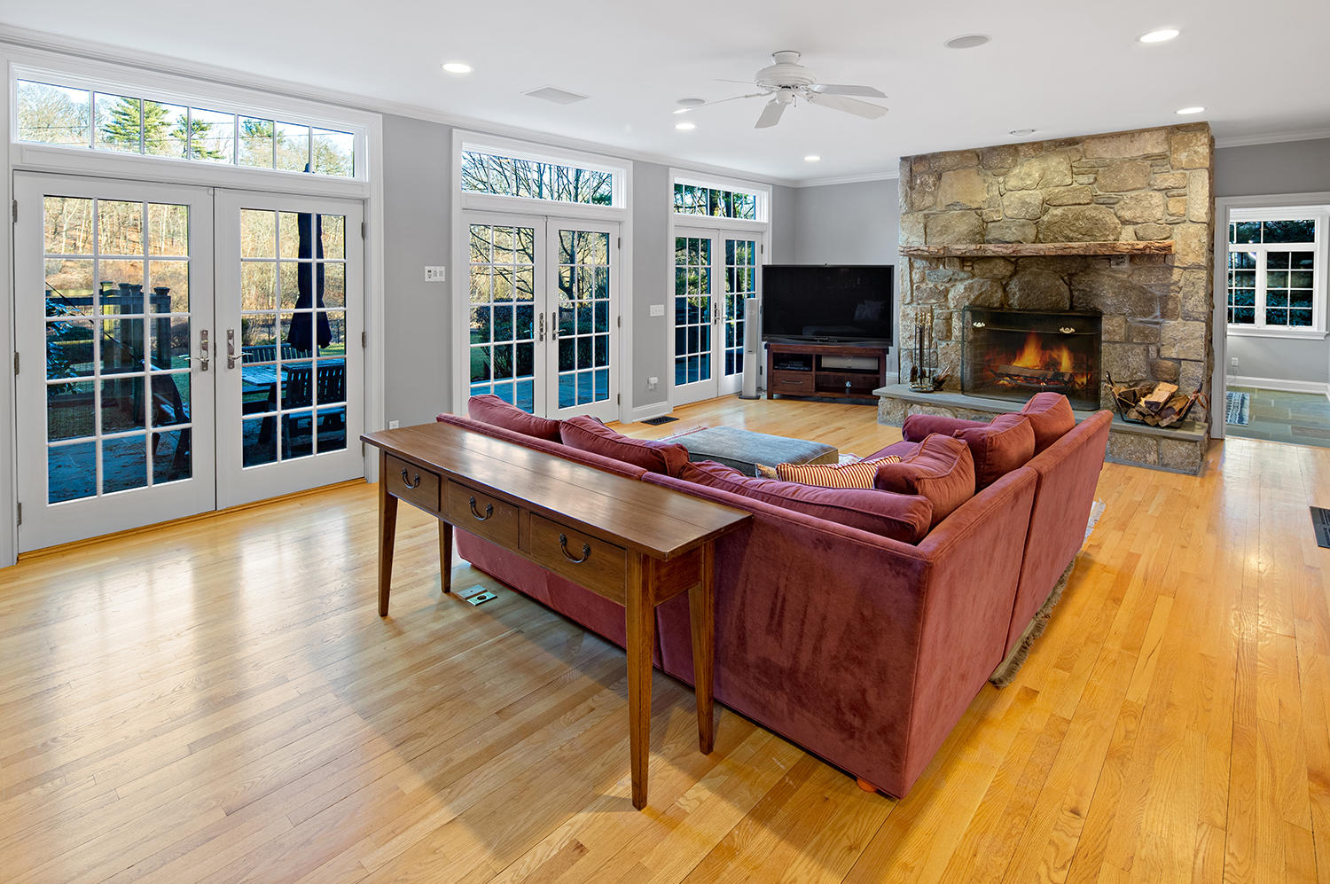 14 Chasmars Pond Road Darien, CT 06820 - Photo 7 of 34 a living room with furniture flat screen tv and a fireplace