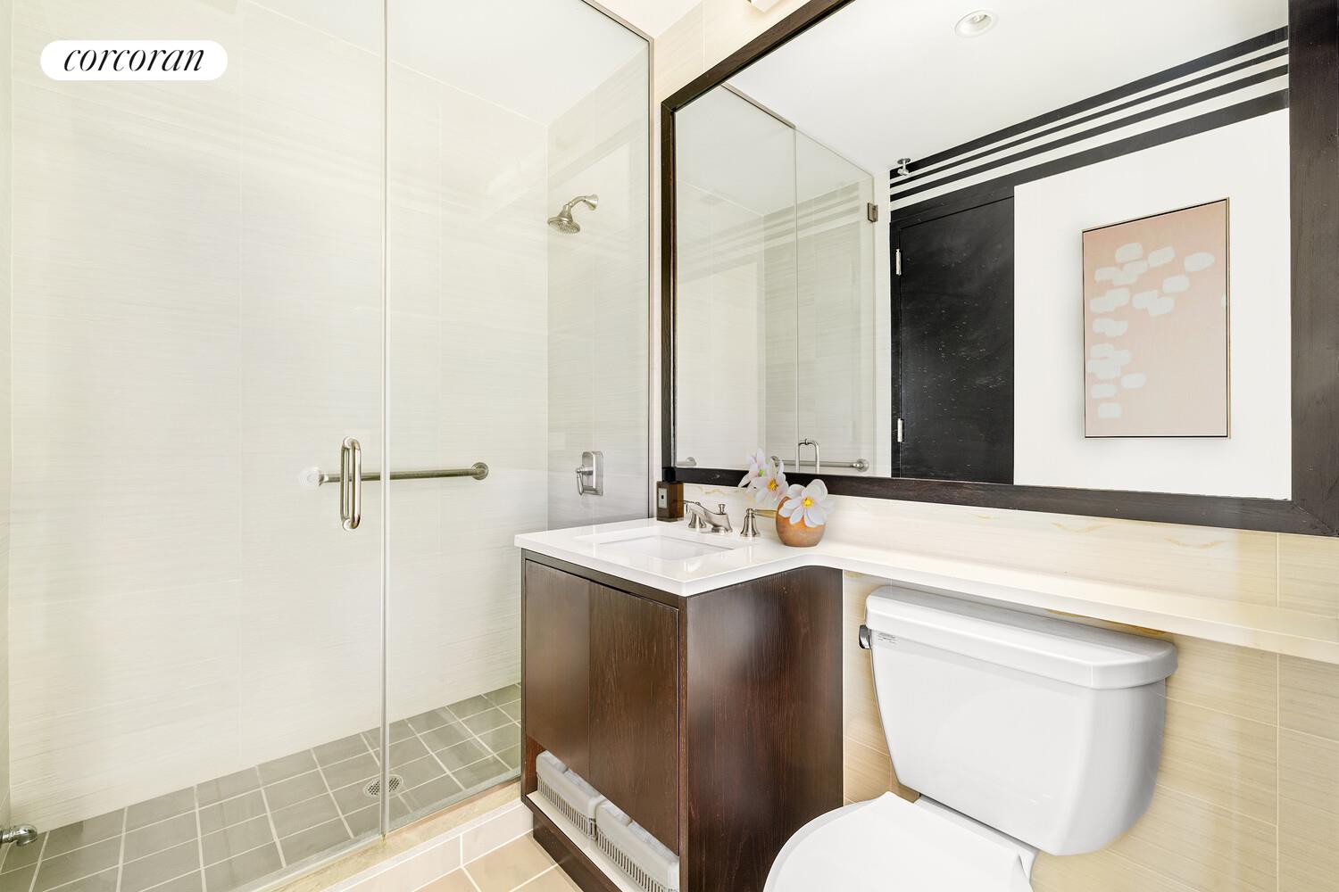 333 East 91st Street, Unit 31CD Manhattan, NY 10128 - Photo 12 of 15 a bathroom with a toilet sink and mirror