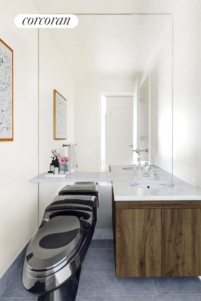 333 East 91st Street, Unit 31CD Manhattan, NY 10128 - Photo 6 of 15 a bathroom with a sink and a mirror