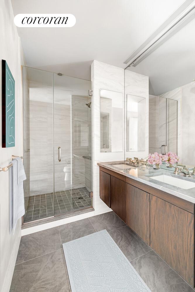 333 East 91st Street, Unit 31CD Manhattan, NY 10128 - Photo 8 of 15 a bathroom with a granite countertop sink mirror and double