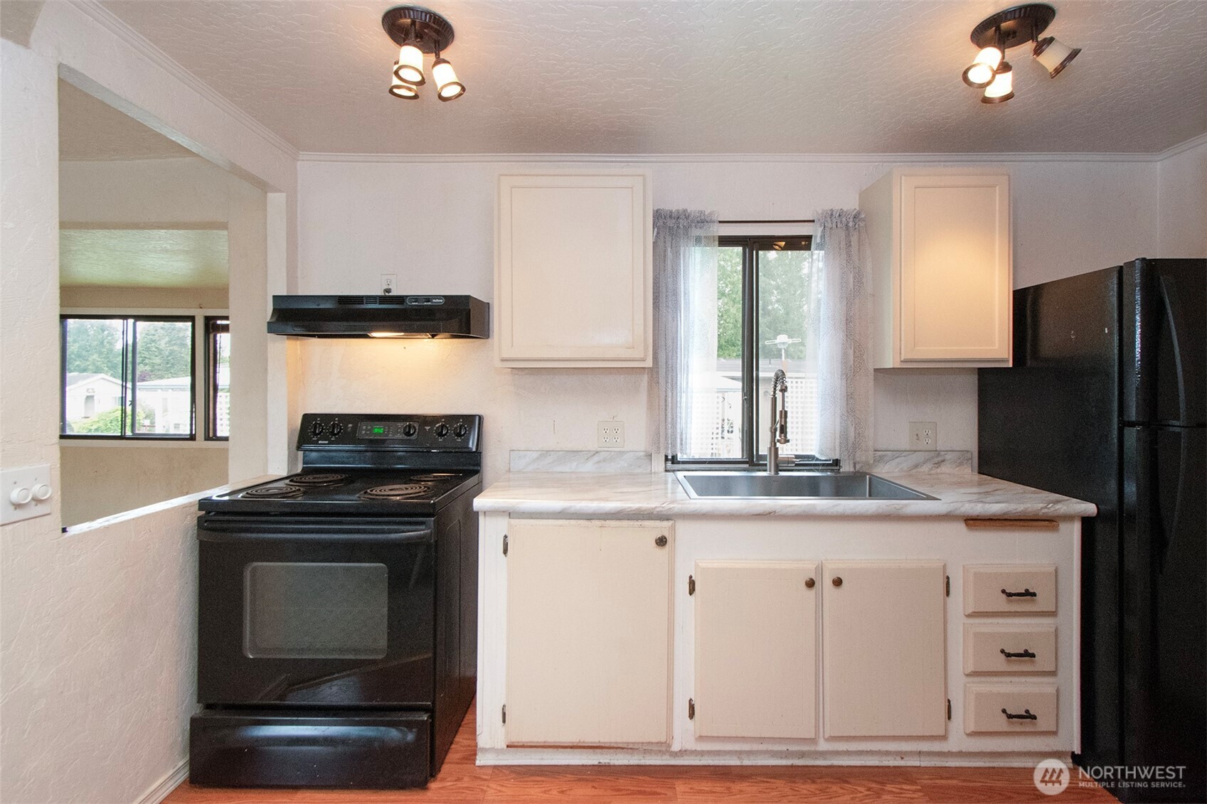90 Baywood Village Road, Unit 34 Sequim, WA 98382 - Photo 16 of 40 a kitchen with granite countertop a stove sink and refrigerator