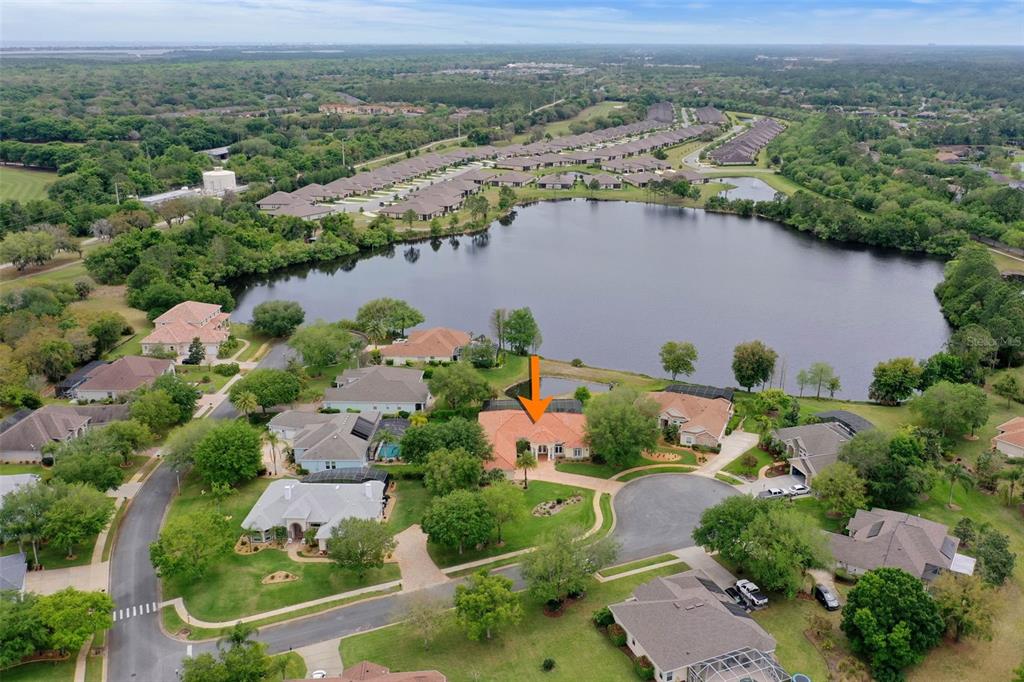 an aerial view of lake residential house with swimming pool and green space