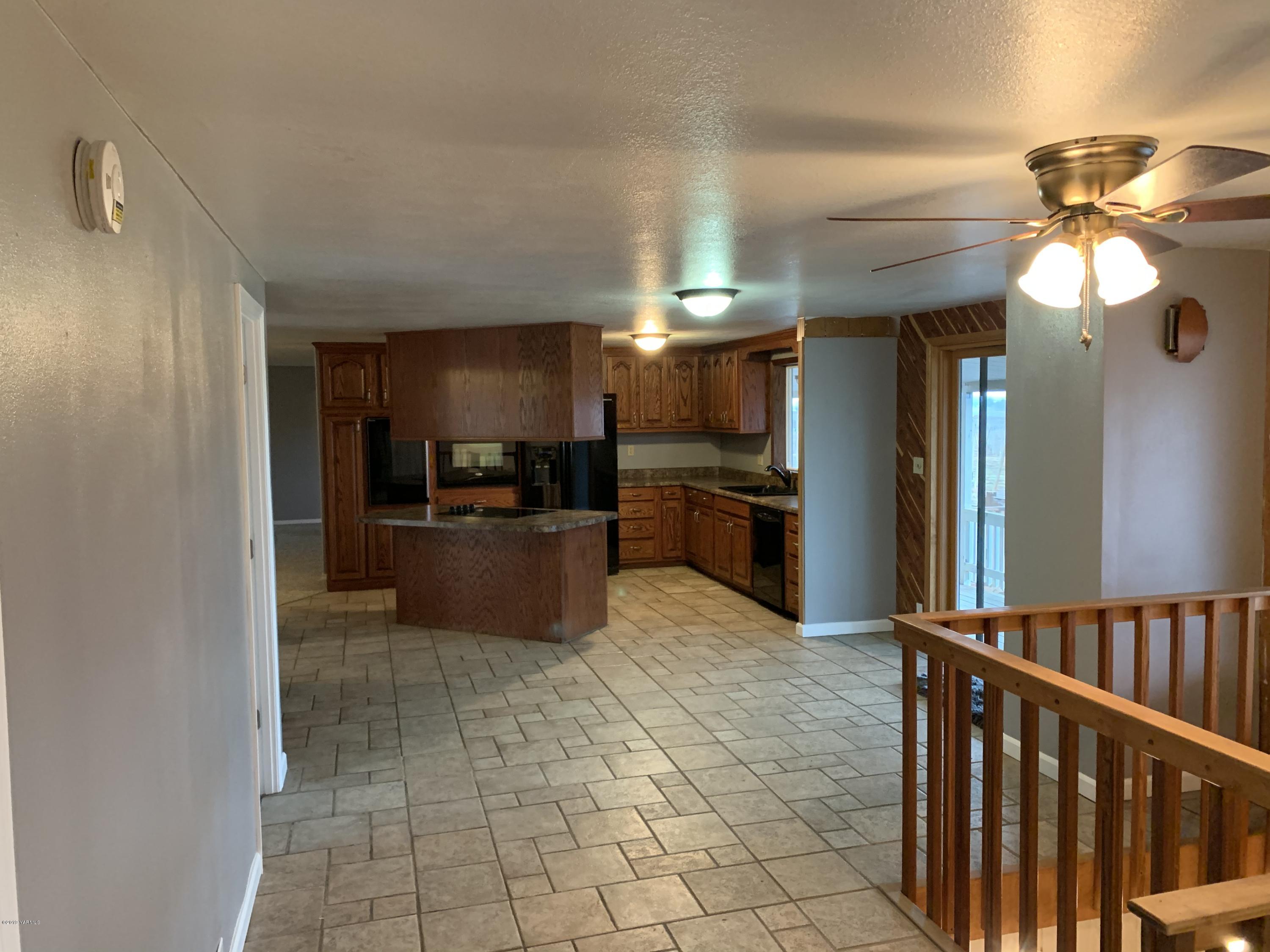 7062 Emerald Road Sunnyside, WA 98944 - Photo 19 of 37 a kitchen with stainless steel appliances granite countertop a refrigerator and a sink