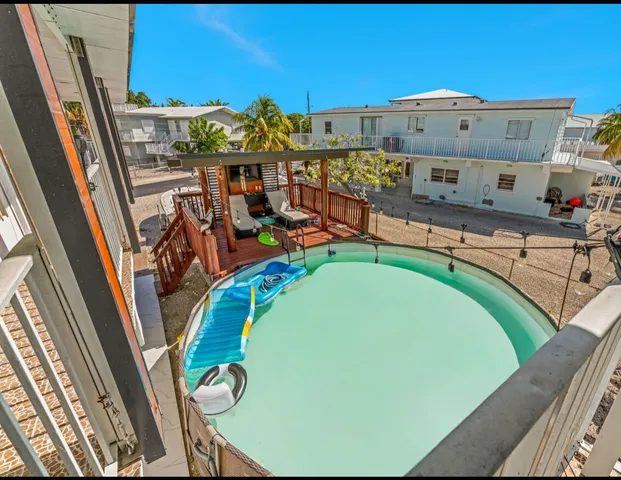 a living room with furniture and a view of kitchen