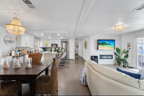 a kitchen with white cabinets and refrigerator