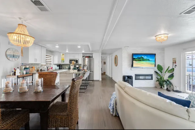 a kitchen with white cabinets and refrigerator