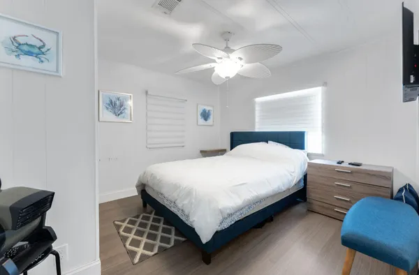 a bedroom with a bed and a chandelier