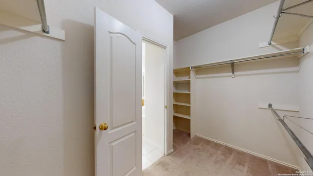 a view of closet area with empty racks