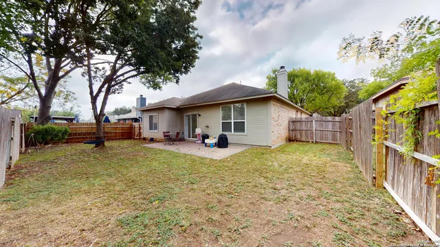 a view of house with backyard and seating area
