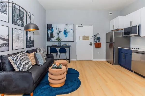 a kitchen with stainless steel appliances granite countertop a refrigerator sink and stove