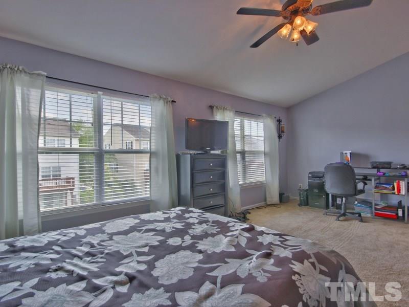 5116 Sandy Banks Road Raleigh, NC 27616 - Photo 13 of 21 a bedroom with a large bed and a window