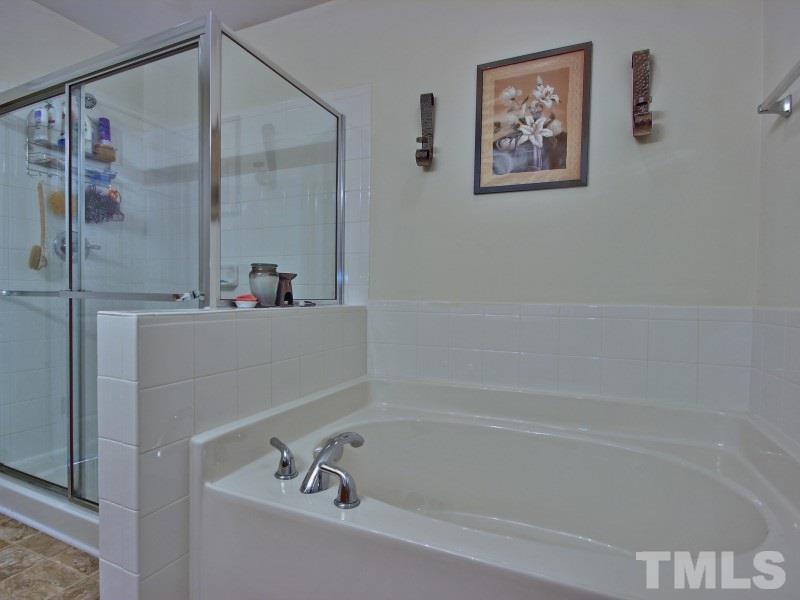 5116 Sandy Banks Road Raleigh, NC 27616 - Photo 15 of 21 a bathroom with a bathtub and shower