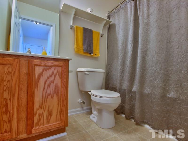 5116 Sandy Banks Road Raleigh, NC 27616 - Photo 18 of 21 a bathroom with a toilet and a shower curtain