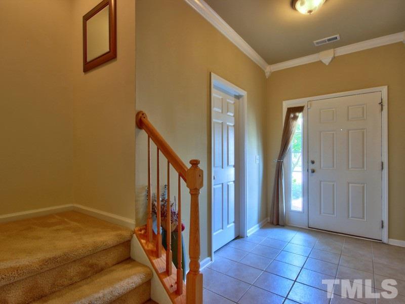 5116 Sandy Banks Road Raleigh, NC 27616 - Photo 4 of 21 a view of a livingroom with an empty space and staircase