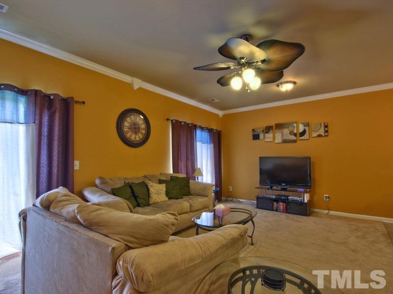 5116 Sandy Banks Road Raleigh, NC 27616 - Photo 6 of 21 a living room with furniture and a flat screen tv