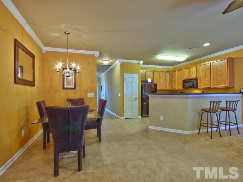 5116 Sandy Banks Road Raleigh, NC 27616 - Photo 8 of 21 a view of a dining room with furniture and a chandelier