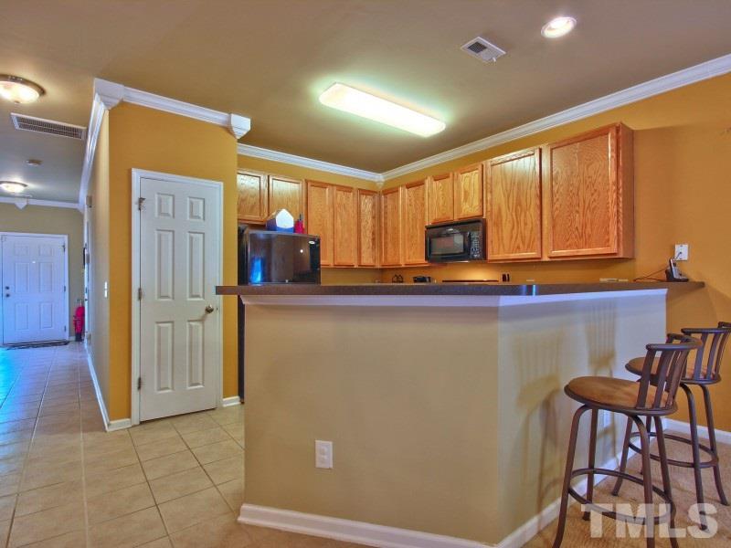 5116 Sandy Banks Road Raleigh, NC 27616 - Photo 10 of 21 a view of a refrigerator and chair in a room