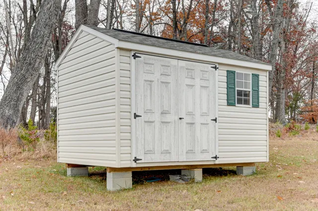 a view of a house with a yard and sitting area