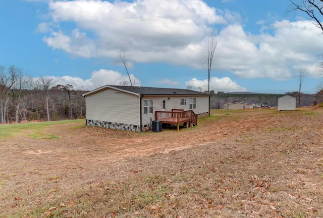 a view of a yard in front of a house with large trees