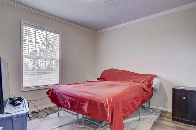 a bedroom with a bed and a flat screen tv