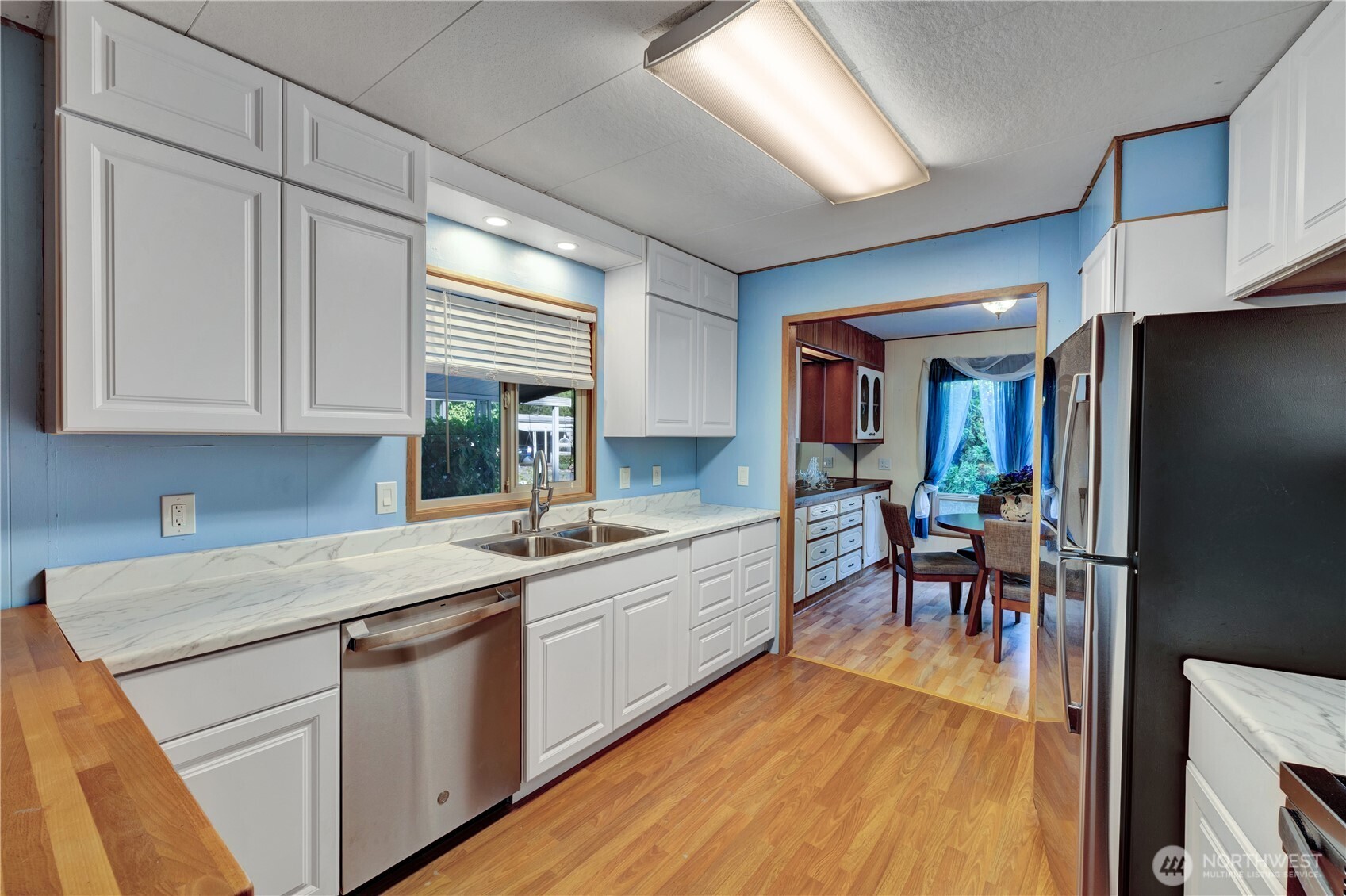 18425 Northeast 95th Street, Unit 110 Redmond, WA 98052 - Photo 7 of 25 a kitchen with white cabinets and sink