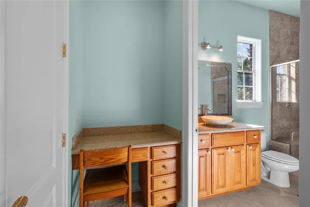 a bathroom with a toilet a sink and a shower
