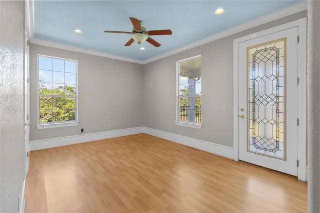 an empty room with windows and closet